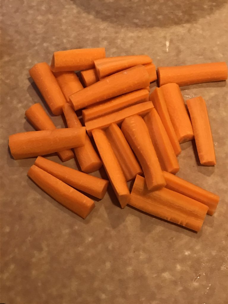 Cut Up Carrots on Cutting Board