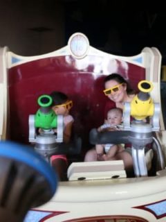 Mom, toddler, and baby on Disneyland ride