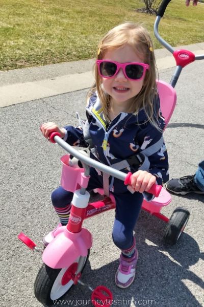 Child Riding Bike Smiling