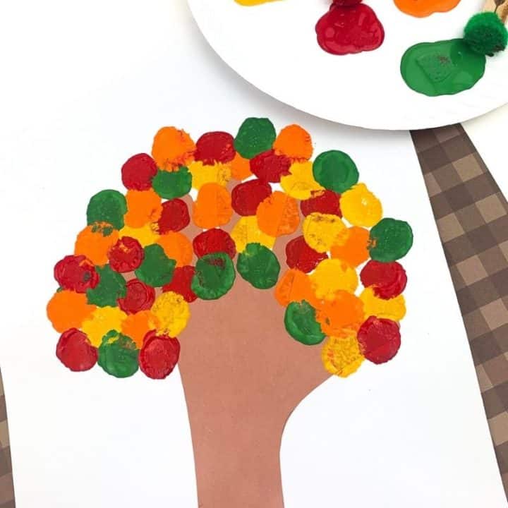 Fall Tree Craft with paints and clothespin pom poms on a paper plate