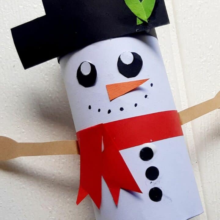 Snowman made out of a toilet paper roll and paper