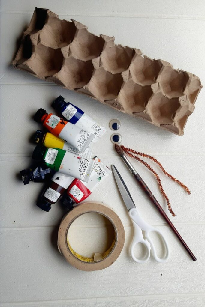 supplies needed to make the caterpillar craft on white table